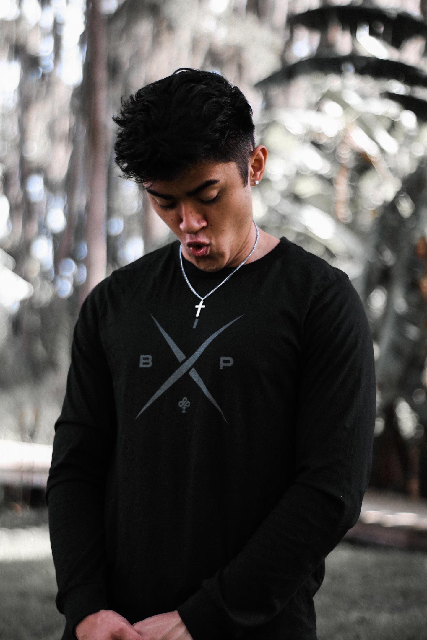 Ricky Ireland wearing the Ireland Boys Productions introduces STEALTH merch ft X 2.0 logo in Asphalt Grey printed on Bela Canvas long sleeve premium T-shirt