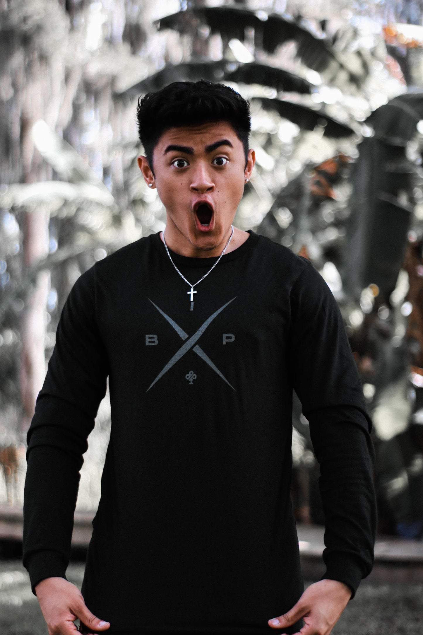 Ricky Ireland wearing the Ireland Boys Productions introduces STEALTH merch ft X 2.0 logo in Asphalt Grey printed on Bela Canvas long sleeve premium T-shirt