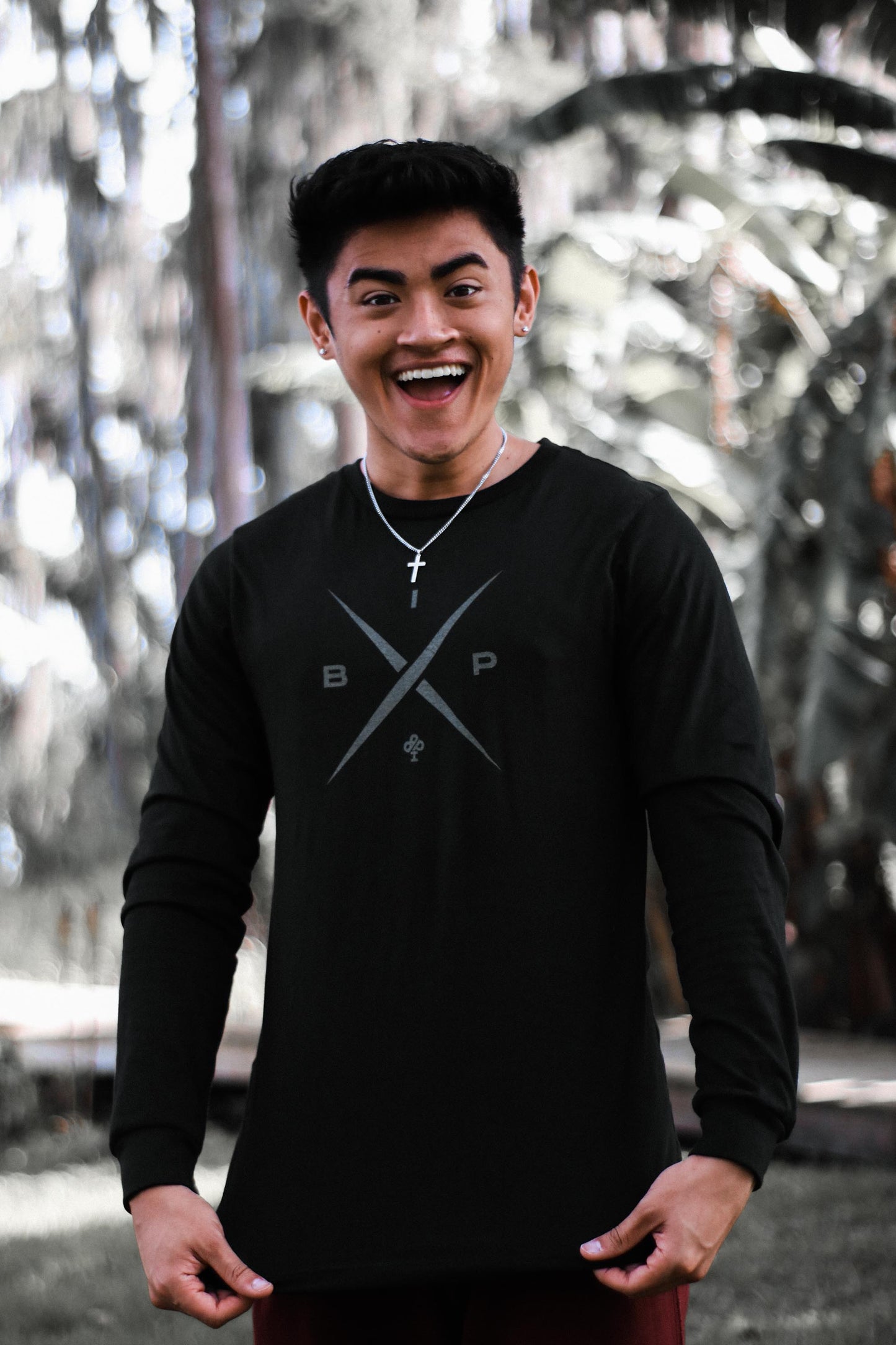 Ricky Ireland wearing the Ireland Boys Productions introduces STEALTH merch ft X 2.0 logo in Asphalt Grey printed on Bela Canvas long sleeve premium T-shirt