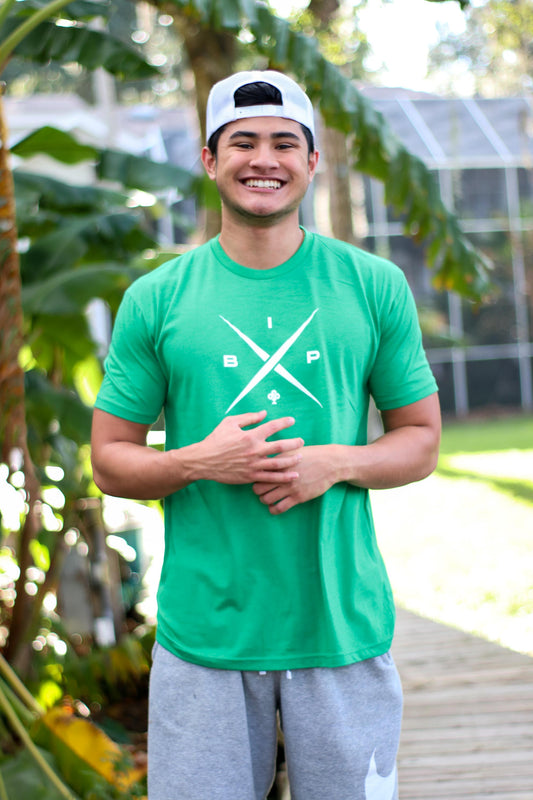 Introducing Nick Ireland wearing the Ireland Boys Productions merch ft X logo 2.0  in Cloud White  printed on Kelly green  NEXT LEVEL premium T-shirt